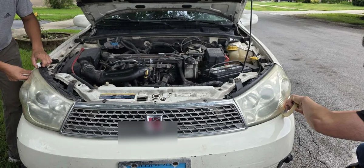 Headlights being taped before restoration process