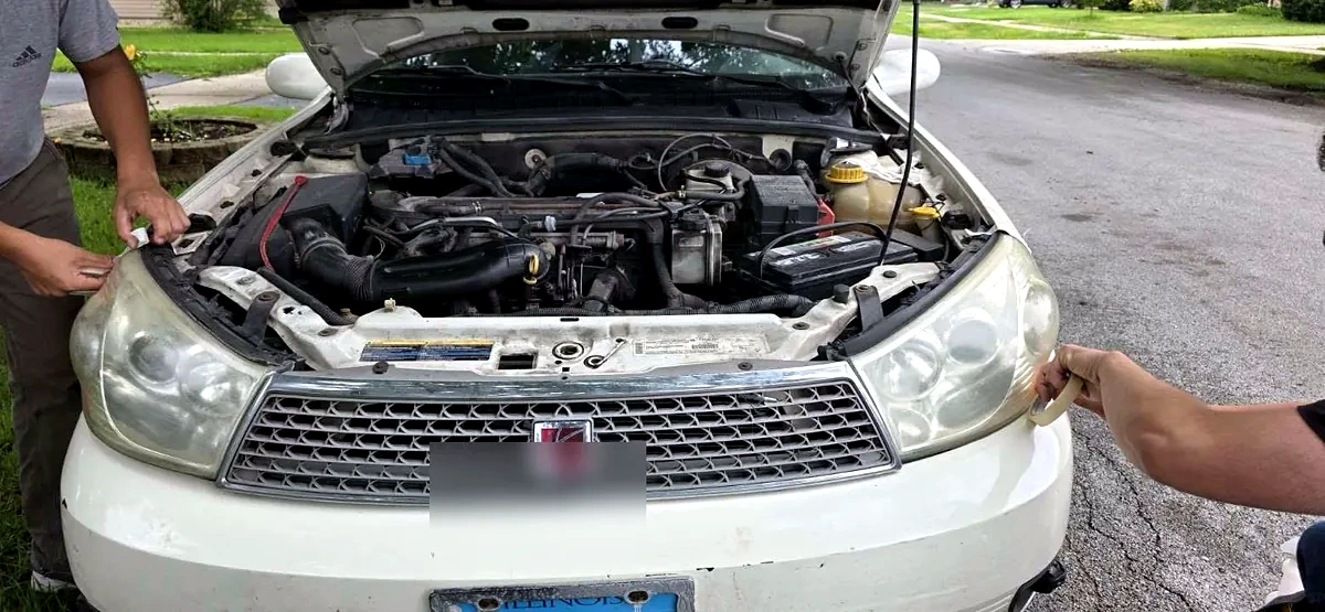 Headlights being taped before restoration process